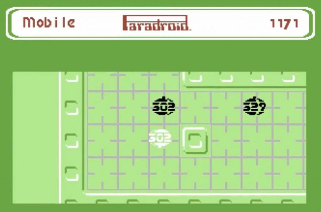 Paradroid on the Commodore 64: the player, now in control of a 302 droid, shown in white beside an enemy 302 and a 329 on a green deck